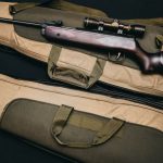 Hunting - Black Rifle With Scope and Brown Gig Bag